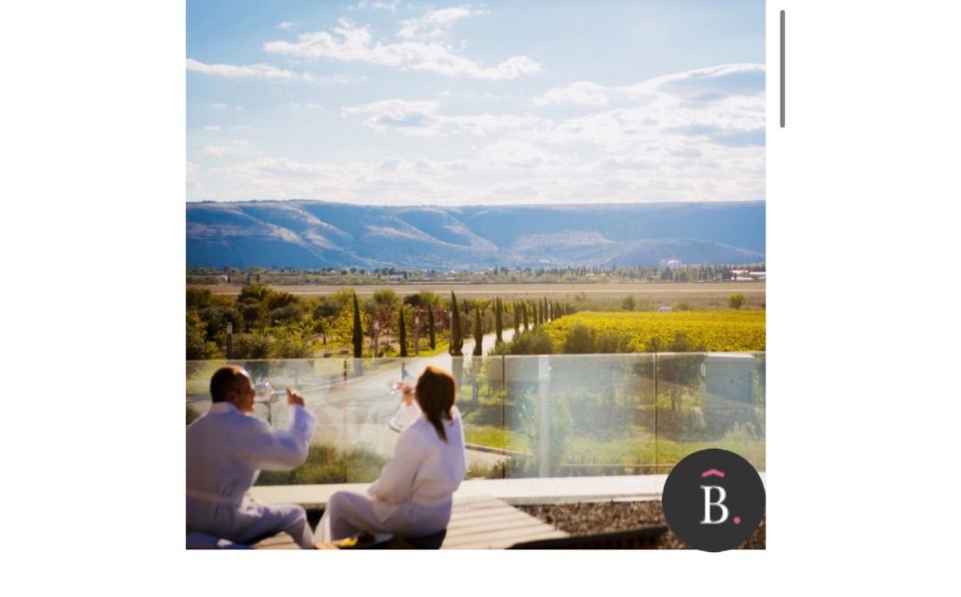 Guests enjoying wine on Emporia's terrace overlooking the vineyards and valley
