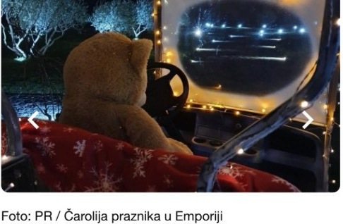 A festively dressed teddy bear rides through Emporia's lantern-lit vineyard on a golf cart