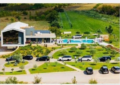 Aerial view of Emporia's Imperial Vineyards estate with Range Rover vehicles gathered among the vines and pool terrace
